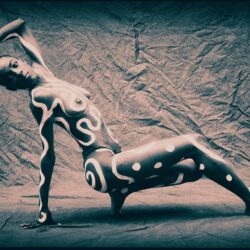 A woman with body paint featuring abstract, white designs poses dynamically against a textured, dark backdrop. Their posture is gracefully balanced, highlighting the intricate, curving patterns on their skin. This striking image would captivate any visitor at an online art gallery or a traditional art gallery alike.