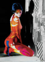 A colorful, abstract painting of a woman kneeling. The woman's body is highlighted in contrasting shades of red, orange, yellow, blue, and purple. She faces the wall, casting a shadow on a patterned black-and-white background. Perfect for any art gallery seeking vibrant pieces or individuals looking to sell your art.