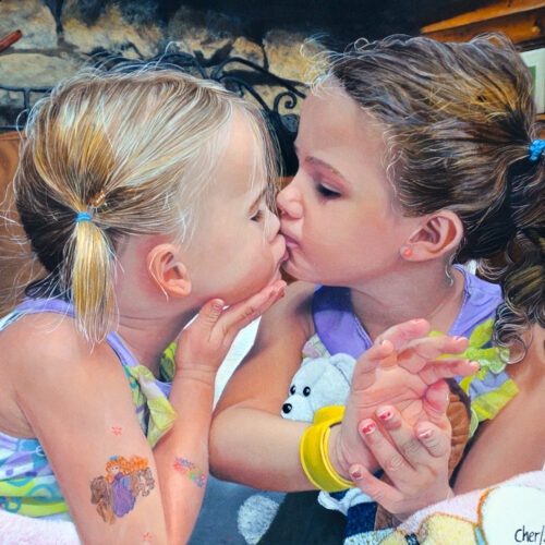 two young girls sit close together indoors, gently kissing each other on the lips. one girl holds a stuffed animal, and both have colorful clothing, braided hair, and temporary tattoos on their arms. they appear affectionate and playful.