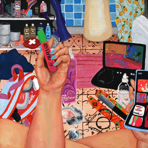 A person sits on a tiled floor, holding a green lighter and a smartphone. Surrounding them are a laptop, bags, toiletries, and various personal items in a colorful, cluttered bathroom setting.