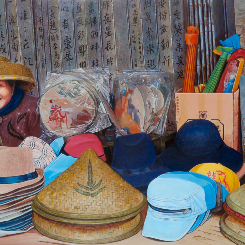 An oil painting shows a smiling older woman wearing a straw conical hat at her stall. She is surrounded by a variety of hats, including fedoras, caps, and traditional straw cones, with calligraphy on the wooden wall behind her.