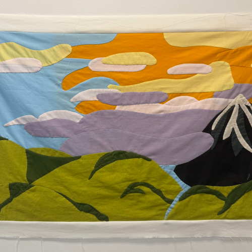 Fabric wall hanging depicting a landscape with green rolling hills, a dark mountain peak, and a stylized sunset sky with layered clouds.