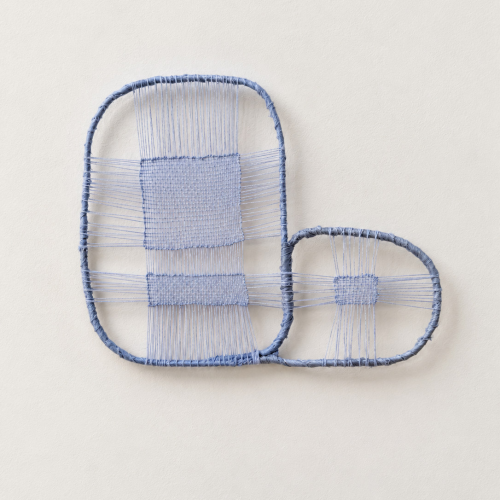 Wall art featuring two connected blue wire frames woven with matching blue thread in a grid pattern.