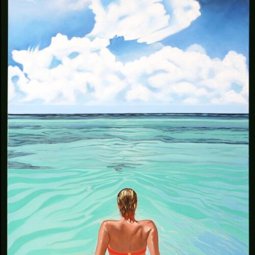 a person with short blond hair wades into clear turquoise water under a dramatic sky filled with white clouds, facing the horizon and distant blue sea.